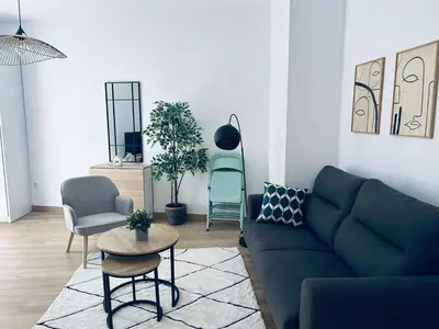 a living room with a blue couch and chairs at Life Apartments Arcos 27 in Jerez de la Frontera