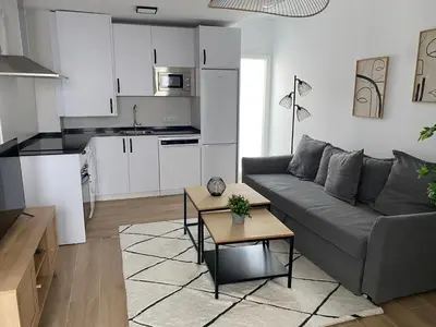 a living room with a couch and a kitchen at Life Apartments Arcos 27 in Jerez de la Frontera