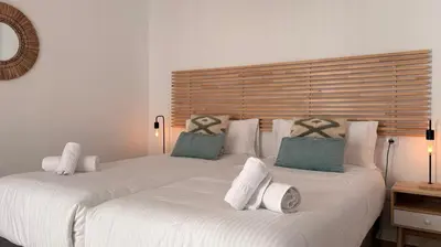 two white beds with pillows on them in a room at Life Apartments Arcos 27 in Jerez de la Frontera