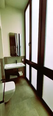 a bathroom with a toilet and a sink and a mirror at Apartamentos Robles 4 by Gades Gestión in Cádiz