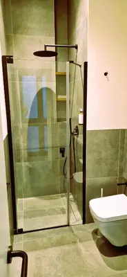 a bathroom with a glass shower and a toilet at Apartamentos Robles 4 by Gades Gestión in Cádiz
