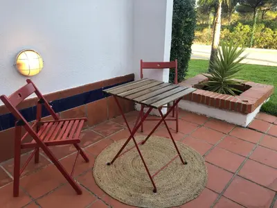 a picnic table and two chairs on a patio at Casa Hortensia in Chiclana de la Frontera