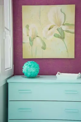a painting of flowers on the wall above a dresser at Apartamento Cádiz Centro Histórico in Cádiz