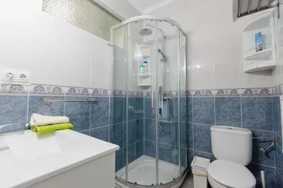 a bathroom with a shower and a toilet and a sink at Apartamento Cádiz Centro Histórico in Cádiz