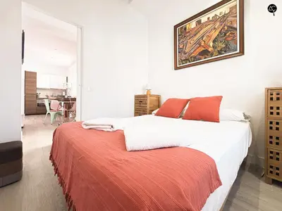 a bedroom with a bed and a painting on the wall at Penthouse Libertad Grupo AC Gestion in Cádiz