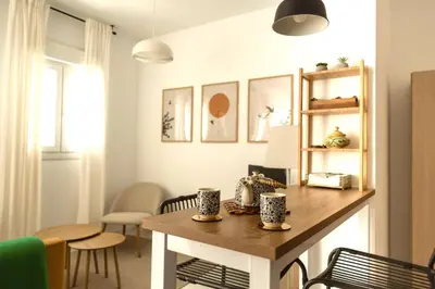 a living room with a wooden table and chairs at SOL y LETIZIA in Jerez de la Frontera
