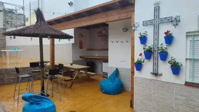 an alley with potted plants in a building at Apartamento Pacífico in Chipiona