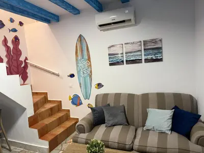 a living room with a wall with a tv on it at Apartamento Pacífico in Chipiona