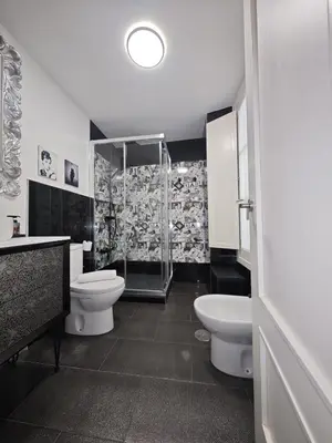 a bathroom with two toilets and a shower at El Rincón de Ro Little Apartments in Cádiz