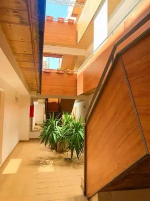an open hallway with wooden ceilings and plants at Encantador apartamento in Sanlúcar de Barrameda