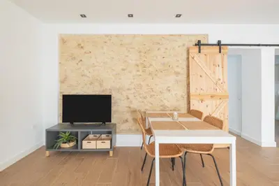a living room with a table and a tv at Mirador de la Peña in Arcos de la Frontera