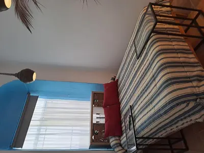 a bedroom with a bed and a window at Alojamiento Rosalía in Sanlúcar de Barrameda