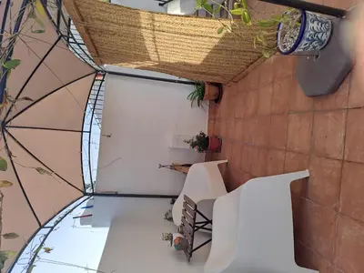 an internal view of a building with stairs and plants at Alojamiento Rosalía in Sanlúcar de Barrameda