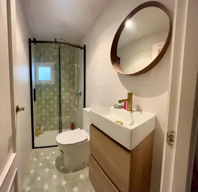 a bathroom with a toilet and a sink and a mirror at nr15 in the heart of Cadiz in Cádiz