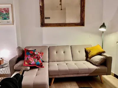 a living room with a couch with pillows on it at nr15 in the heart of Cadiz in Cádiz