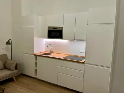 a kitchen with white cabinets and a sink and a microwave at nr15 in the heart of Cadiz in Cádiz