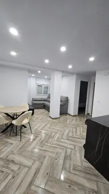 a living room with a table and a couch at Apartamento el tejar in El Puerto de Santa María