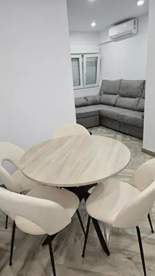 a table and chairs in a living room with a couch at Apartamento el tejar in El Puerto de Santa María