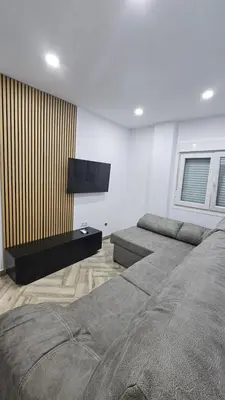 a bedroom with two beds and a flat screen tv at Apartamento el tejar in El Puerto de Santa María
