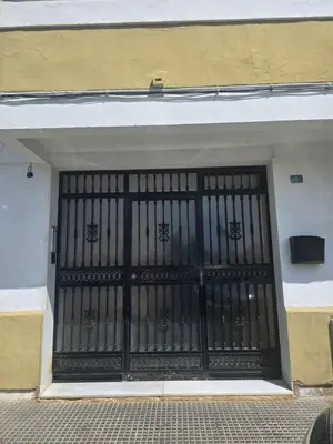 a garage door with a black metal gate at Apartamento el tejar in El Puerto de Santa María