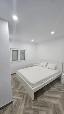 a white bedroom with a large white bed in it at Apartamento el tejar in El Puerto de Santa María