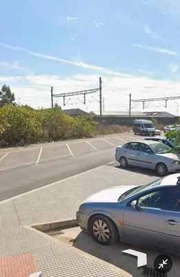 a parking lot with two cars parked in it at Apartamento el tejar in El Puerto de Santa María