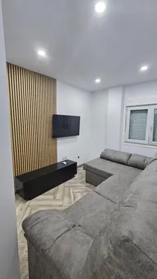 a bedroom with two beds and a flat screen tv at Apartamento el tejar in El Puerto de Santa María