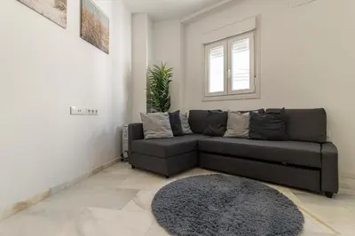 a living room with a couch and a rug at Jerez Centro Stay in Jerez de la Frontera