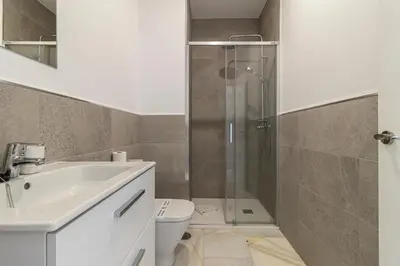 a bathroom with a shower and a sink and a toilet at Jerez Centro Stay in Jerez de la Frontera