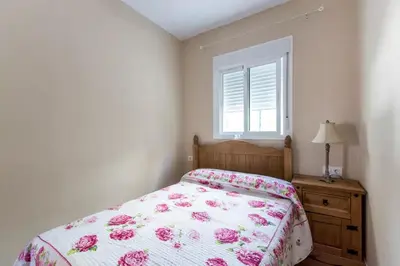 a bedroom with a bed and a window at Turivivienda La Goleta in Conil de la Frontera