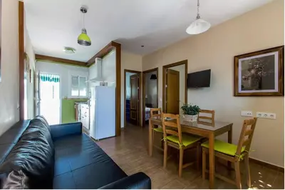 a living room with a couch and a table at Turivivienda La Goleta in Conil de la Frontera