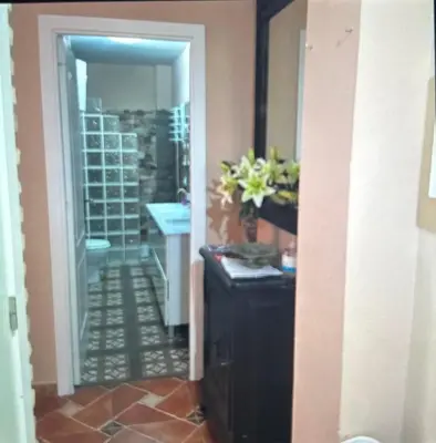 a hallway with a room with a vase of flowers at Piso en el centro de sanlucar Bda in Sanlúcar de Barrameda