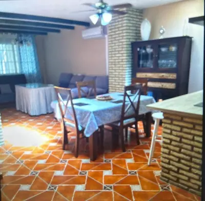 a dining room with a table and chairs in a room at Piso en el centro de sanlucar Bda in Sanlúcar de Barrameda
