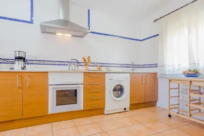 a kitchen with a washing machine and a washer at Casa Mariana in Conil de la Frontera