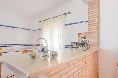 a kitchen with a counter with a bike on it at Casa Mariana in Conil de la Frontera