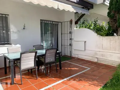 a table and chairs sitting on a patio at Apartamento Las Dunas Costa Ballena in Rota