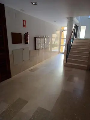 a living room with a staircase and a stair case at Apartamento Bahía de la Luz in Rota