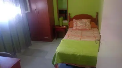 a bedroom with a bed in a room with green walls at Piso a buen precio con 3 HABITACIONES in Puerto Real