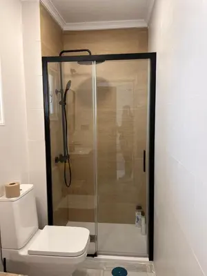 a bathroom with a toilet and a glass shower at Estudio Cruz del Mar in Chipiona