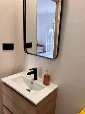 a bathroom with a sink and a mirror at Estudio Cruz del Mar in Chipiona
