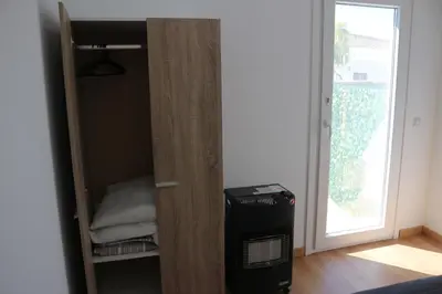 a room with a door to a closet with a window at La Barrosa Private Suites in Novo Sancti Petri