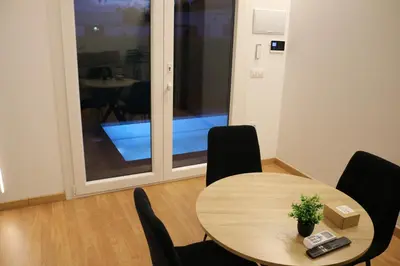 a table and chairs in a room with a window at La Barrosa Private Suites in Novo Sancti Petri