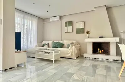 a living room with a couch and a fireplace at Complejo Atlantico in Novo Sancti Petri
