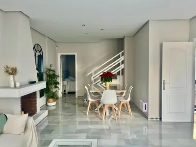 a living room with a table and chairs at Complejo Atlantico in Novo Sancti Petri