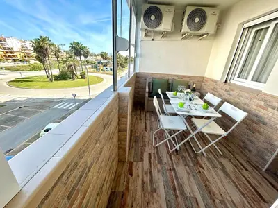 a patio with a table and chairs on a balcony at GATU Marítimo 