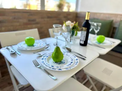 a table with a bottle of wine and a green pear on it at GATU Marítimo 