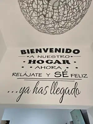a sign on a wall with a disco ball at Casa El Canario by Sanlúcar Housing in Sanlúcar de Barrameda