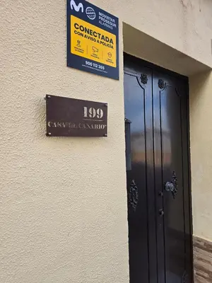a sign on the side of a building with a door at Casa El Canario by Sanlúcar Housing in Sanlúcar de Barrameda