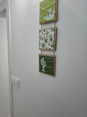 a wall with four pictures on a wall with a door at Casa El Canario by Sanlúcar Housing in Sanlúcar de Barrameda