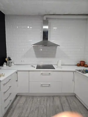 a kitchen with white cabinets and a stove top oven at Casa El Canario by Sanlúcar Housing in Sanlúcar de Barrameda